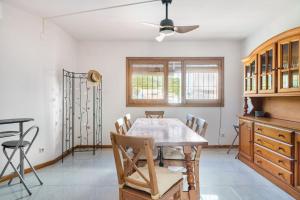a dining room with a wooden table and chairs at Seamount, a beautiful house overlooking Tamariu in Tamariu