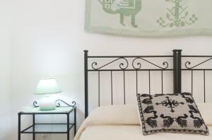 1 dormitorio con 1 cama y 1 mesa con lámpara en [15 min da Olbia] Green Country, en Porto San Paolo