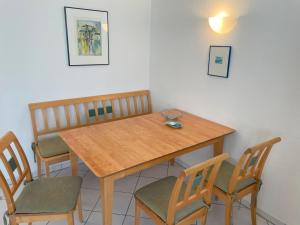 a dining room table with chairs and a wooden table at Apartment Lotte in Zempin