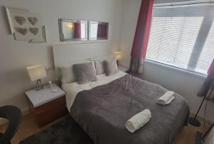 a bedroom with a bed with two pillows on it at TravelMore in Letterkenny