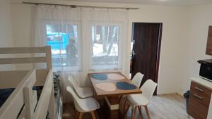 a kitchen with a table and chairs in a room at Chatka Maya Máchovo jezero in Doksy