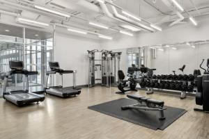 a gym with a lot of treadmills and machines at Aloft Chicago O'Hare in Rosemont