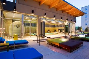 a patio with tables and benches on a building at Aloft Chicago O'Hare in Rosemont