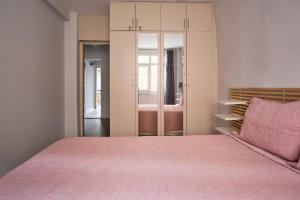a bedroom with a pink bed and a closet at Taxim home with terrace in Istanbul