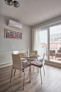 a dining room with a table and chairs and a window at Taxim home with terrace in Istanbul