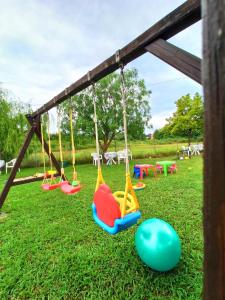 a swing set in a park with playground equipment at Demis Apartments in Sidari