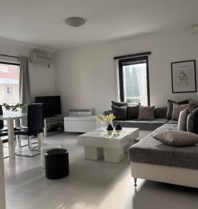 a living room with a couch and a table at Apartments Villa Stefan in Budva