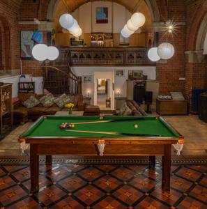a living room with a pool table in it at Mountain Church in Capel-Curig