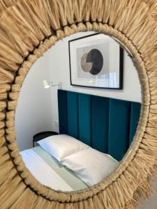 a mirror reflecting a bedroom with a bed in a room at Apartament Bari Playa in Playa de Gandia