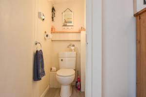 a small bathroom with a toilet and a mirror at Harbour Life in Yarmouth