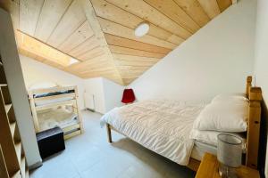 a bedroom with a bed and a wooden ceiling at 100 m near the Cité Vauban in Briançon in Briançon