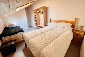 a bedroom with a large bed and aicter at 100 m near the Cité Vauban in Briançon in Briançon