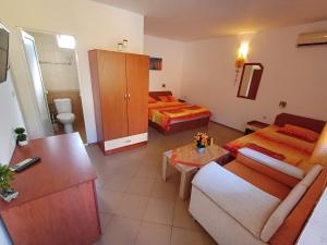 a living room with two beds and a couch at Dom Zaharievi in Byala