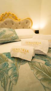 two towels are sitting on top of a bed at Sensoria Naxos Suites in Giardini Naxos