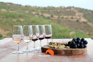 a group of wine glasses and a tray of cheese and grapes at #097 Casa Antonieta 2 by Home Holidays in Albufeira