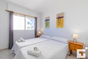 Łóżko lub łóżka w pokoju w obiekcie Apartamento Apolo XVI 67 - Grupo Turis