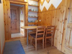 a dining room with a wooden table and chairs at Haus Hanshois in Millstatt