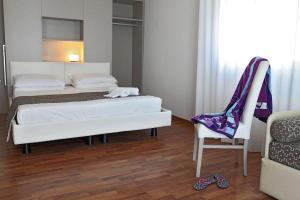 Postel nebo postele na pokoji v ubytování Hotel Columbia & Ninfea