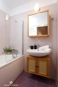 a bathroom with a sink and a mirror and a shower at Elegant Concept Studio in Bucharest