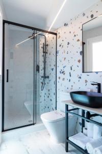 a bathroom with a glass shower and a sink at Hostal Boutique La Mar Serena in Peñíscola