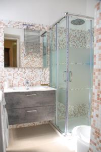 a bathroom with a shower and a sink and a toilet at Casa Liberty - WelcHome in Cannobio
