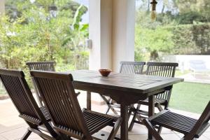 a wooden table and chairs on a porch at LETS HOLIDAYS Luxury house in Cala Llevado in Tossa de Mar