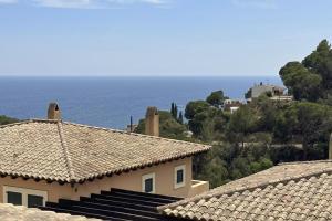 a view of the ocean from the roofs of houses at LETS HOLIDAYS Luxury house in Cala Llevado in Tossa de Mar