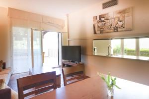 a living room with a table and a television at LETS HOLIDAYS Luxury house in Cala Llevado in Tossa de Mar