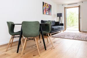 a living room with a table and chairs and a couch at Design Appartements Ehrenhausen in Ehrenhausen