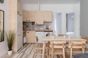 a kitchen and dining room with a table and chairs at Charming and great 3 beds apartment in Tetuán by SharingCo in Madrid