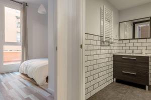 a bedroom with a bed and a sink and a mirror at Charming and great 3 beds apartment in Tetuán by SharingCo in Madrid