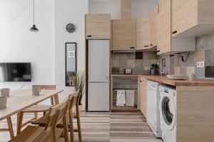 a kitchen with a refrigerator and a table and chairs at Charming and great 3 beds apartment in Tetuán by SharingCo in Madrid