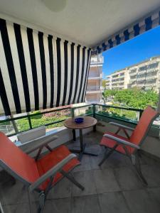 a balcony with two chairs and a table with a view at Costa Daurada Apartaments - COLON in Salou