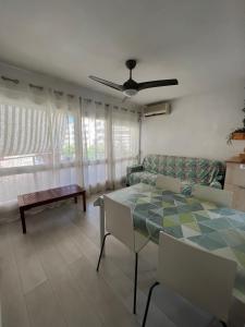 a living room with a table and a couch at Costa Daurada Apartaments - COLON in Salou