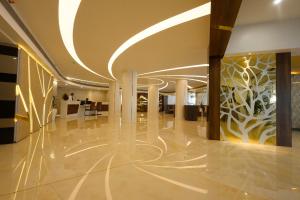 an office lobby with a white and gold wall at Fort Manor in Trivandrum