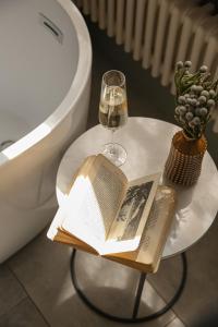 a table with a book and a glass of wine at The Yard in Bath Hotel in Bath