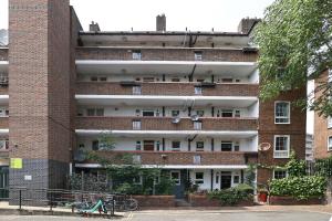 a red brick building with a lot of windows at Bright & modern Islington 2BD apt for 6 in London