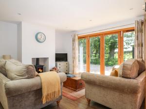 a living room with two chairs and a fireplace at Badgers Sett in Fareham