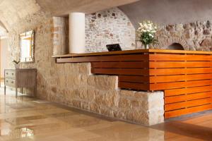 a stone wall with a desk in a room at Hapimag Resort Budapest in Budapest