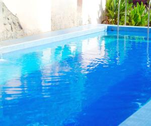 a large blue swimming pool with blue water at Apartamenty Lambert Ustronie Morskie in Ustronie Morskie