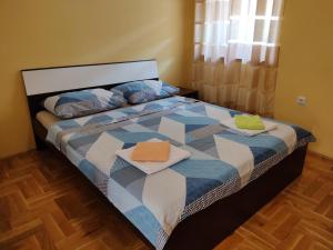 a bedroom with a bed with two towels on it at Apartmani Golomeić in Crikvenica