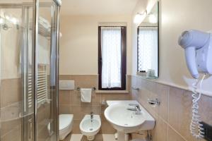 a bathroom with a sink and a toilet and a shower at Hotel Canguro in San Benedetto del Tronto