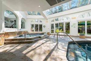 a swimming pool in a large room with windows at Vail Sonnenalp King Hotel Room in Vail