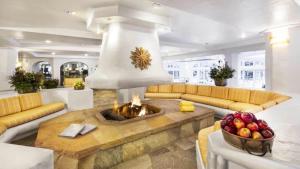 a living room with a fire place in the middle at Vail Sonnenalp King Hotel Room in Vail