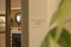 a door with a registration desk sign on it at The Yard in Bath Hotel in Bath