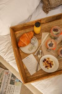 a tray of food with bread and a plate of food at The Yard in Bath Hotel in Bath