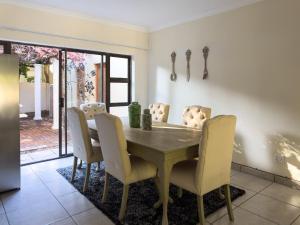 a dining room with a wooden table and chairs at DE WET 5 FRANSCHHOEK in Franschhoek