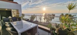 a balcony with a table and chairs and the ocean at The View Beach Penthouse in Limassol
