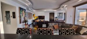 een woonkamer met een bank en een tafel bij The View Beach Penthouse in Limassol