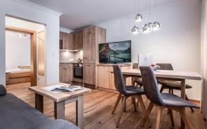 a kitchen and dining room with a table and chairs at Appartements Rosenhof in Pertisau